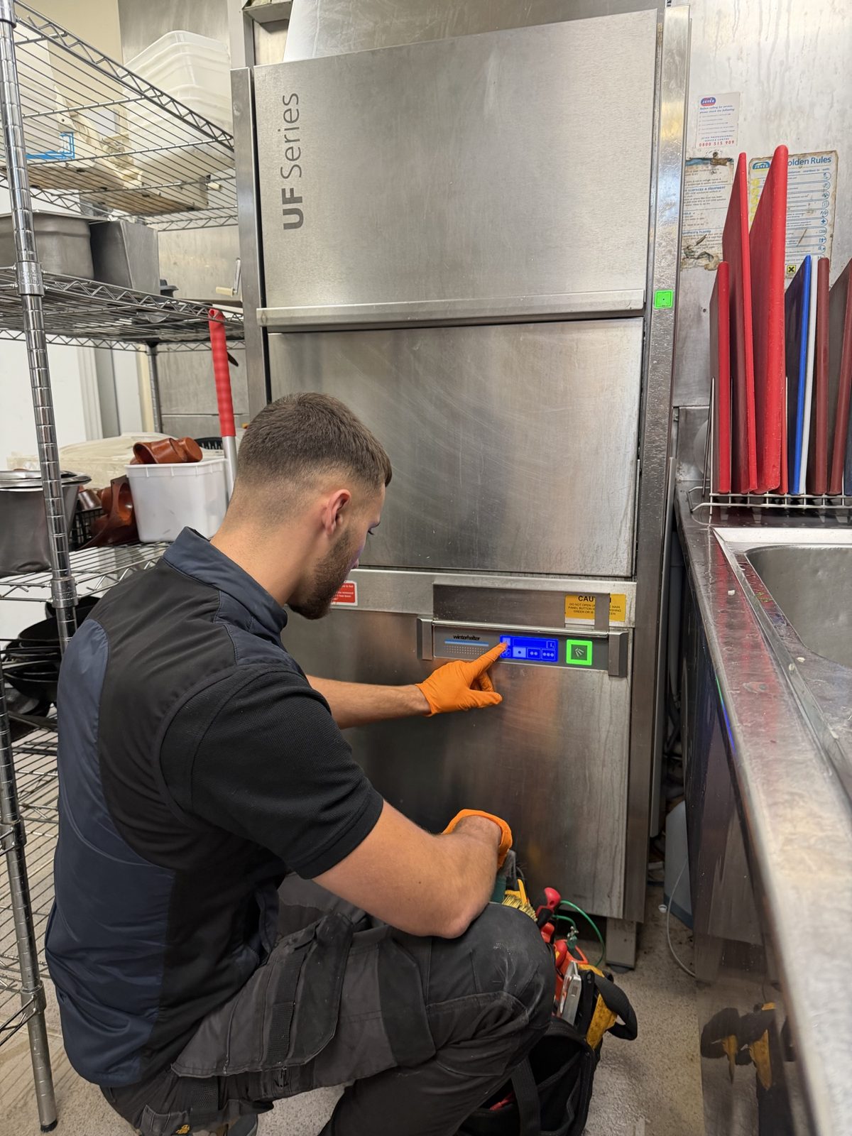 Our technician checking the controls of a Winterhalter UF Series utensil washer